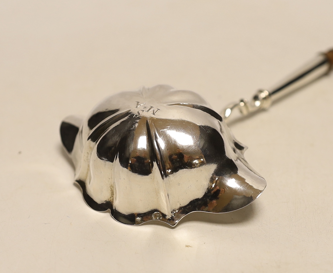 A George II silver toddy ladle, with turned wooden handle, London, 1752, 36.3cm.